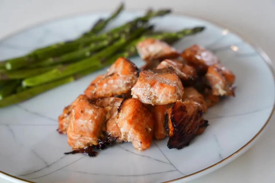 Pieces of fig balsamic salmon served with asparagus