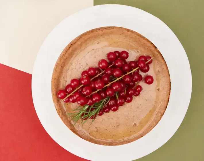 Ginger-spiced pear cheesecake topped with red currants