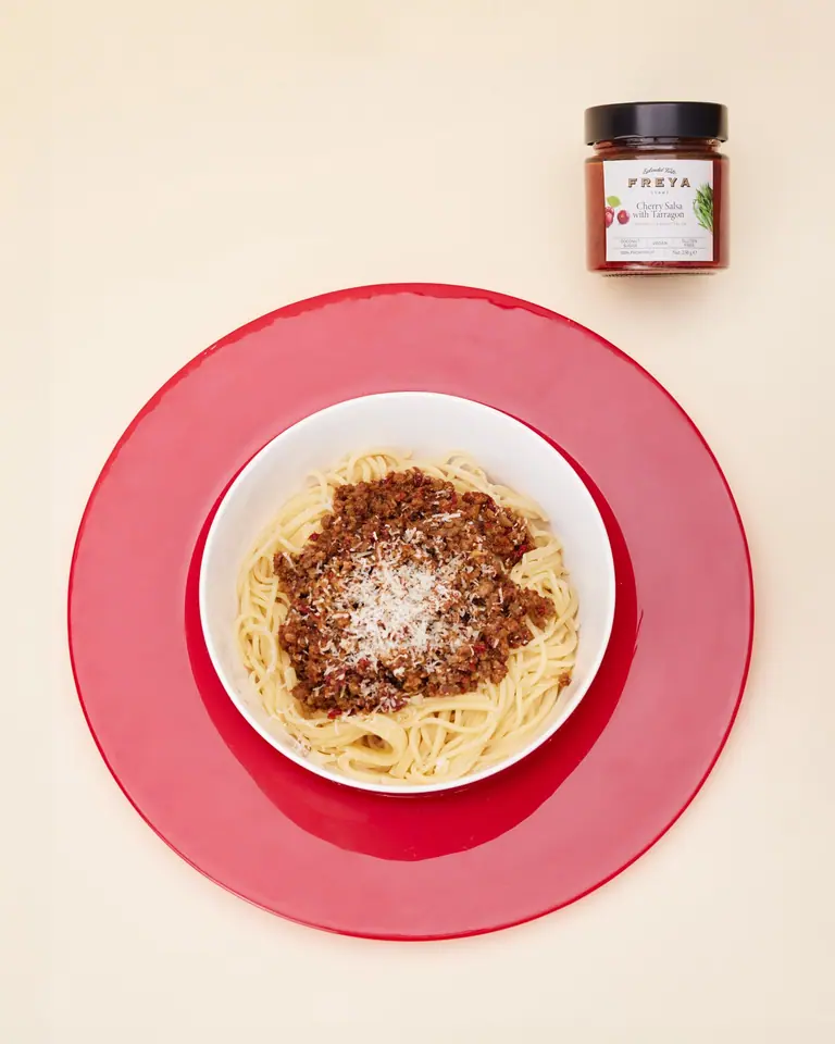 Cherry salsa Bolognese over spaghetti with grated cheese