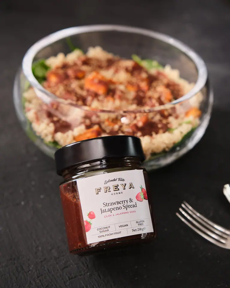 Quinoa salad with strawberry jalapeño dressing in a clear bowl