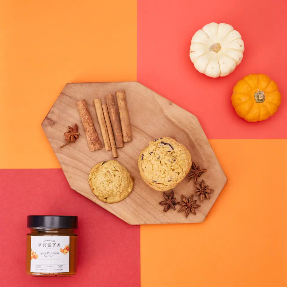 Spiced pumpkin chocolate cookies on a wooden board with cinnamon sticks