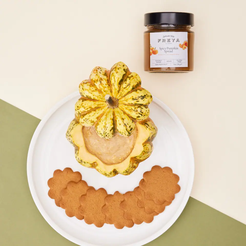 Spiced pumpkin cream cheese dip served in a small pumpkin with cookies